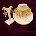 A Sirkar Replica with Diamond Frosting work Floral and Leaf Motif with Pearl work Meenakari Bridal Choker